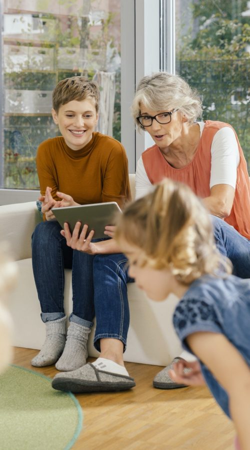 pre-school-teachers-with-tablet-looking-at-children-in-kindergarten.jpg